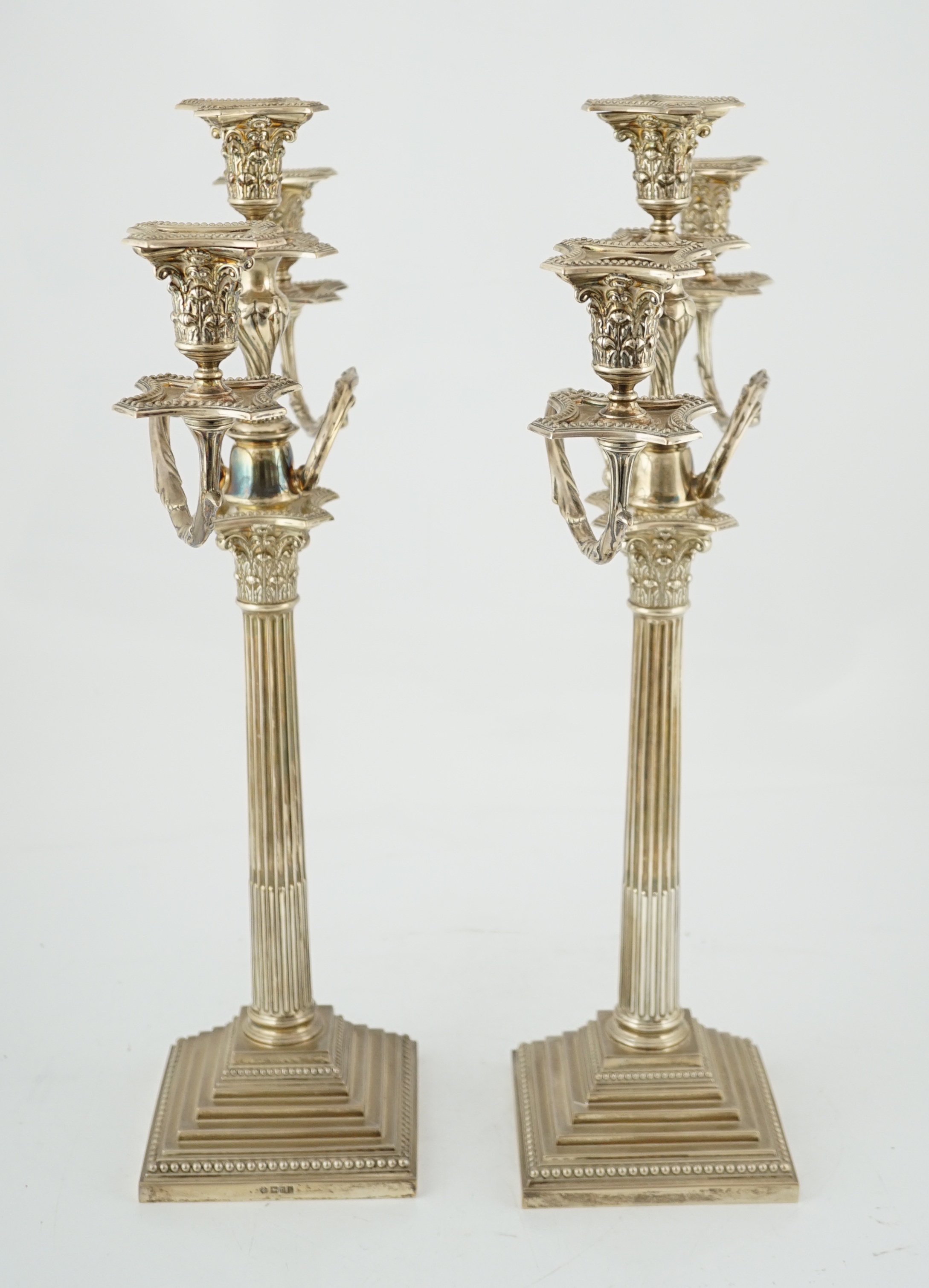 A pair of Edwardian silver two branch, three light Corinthian column candelabra, by William Hutton & Sons